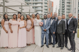 The African-Caribbean Wedding Photography London - Bridal party outside group photo all smiling